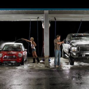 Two people cleaning their cars